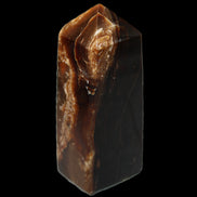 Chocolate Calcite obelisk 100*40mm 286g in sunlight - Rocks and Things Store