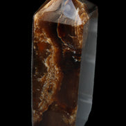 Chocolate Calcite obelisk 100*40mm 286g in sunlight - Rocks and Things Store