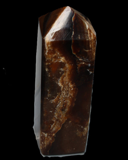 Chocolate Calcite obelisk 100*40mm 286g in sunlight - Rocks and Things Store