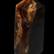Chocolate Calcite obelisk 100*40mm 286g in sunlight - Rocks and Things Store