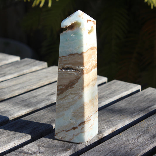 Caribbean aqua blue Calcite obelisk 479g in sunlight - Rocks and Things Store