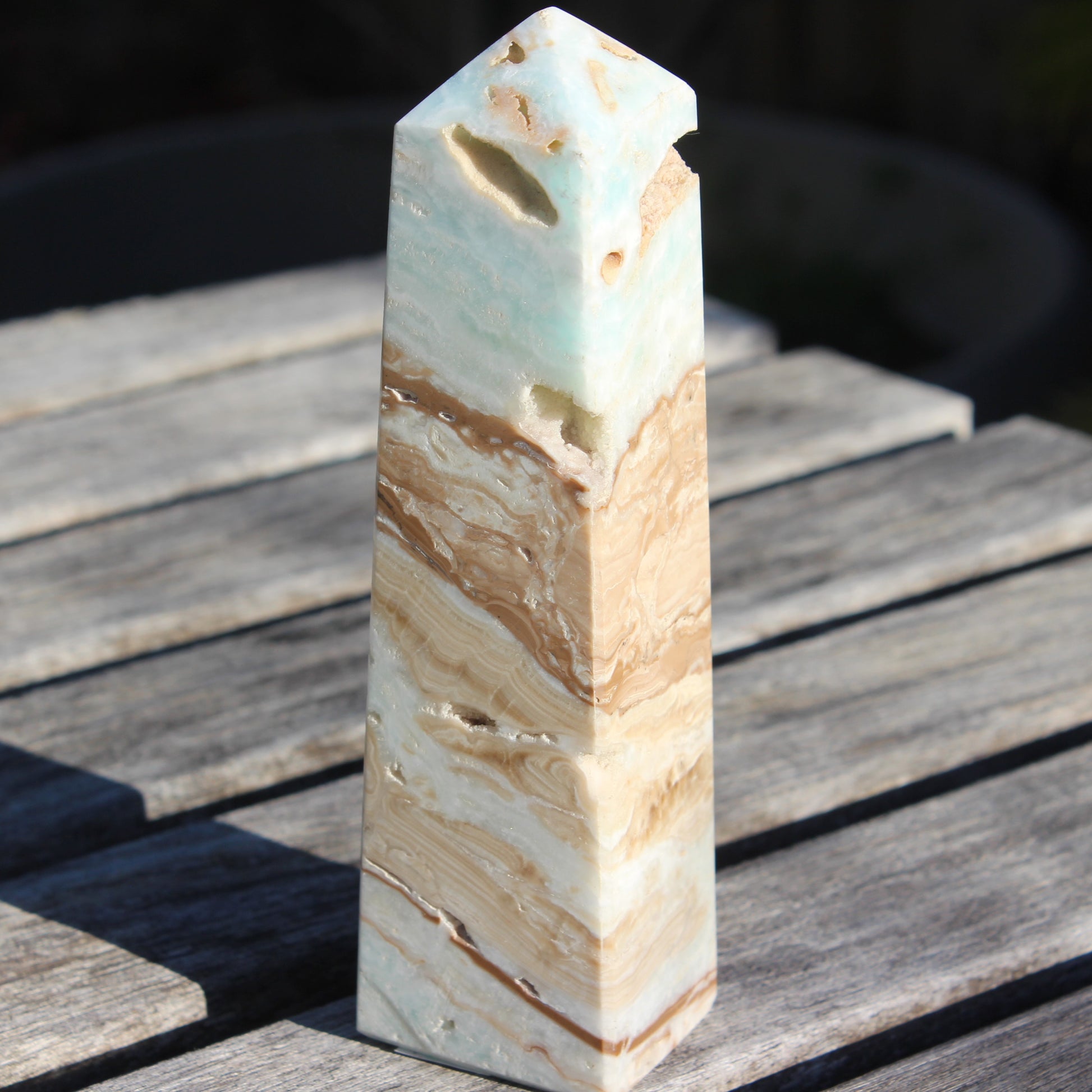 Caribbean aqua blue Calcite obelisk 479g in sunlight - Rocks and Things Store