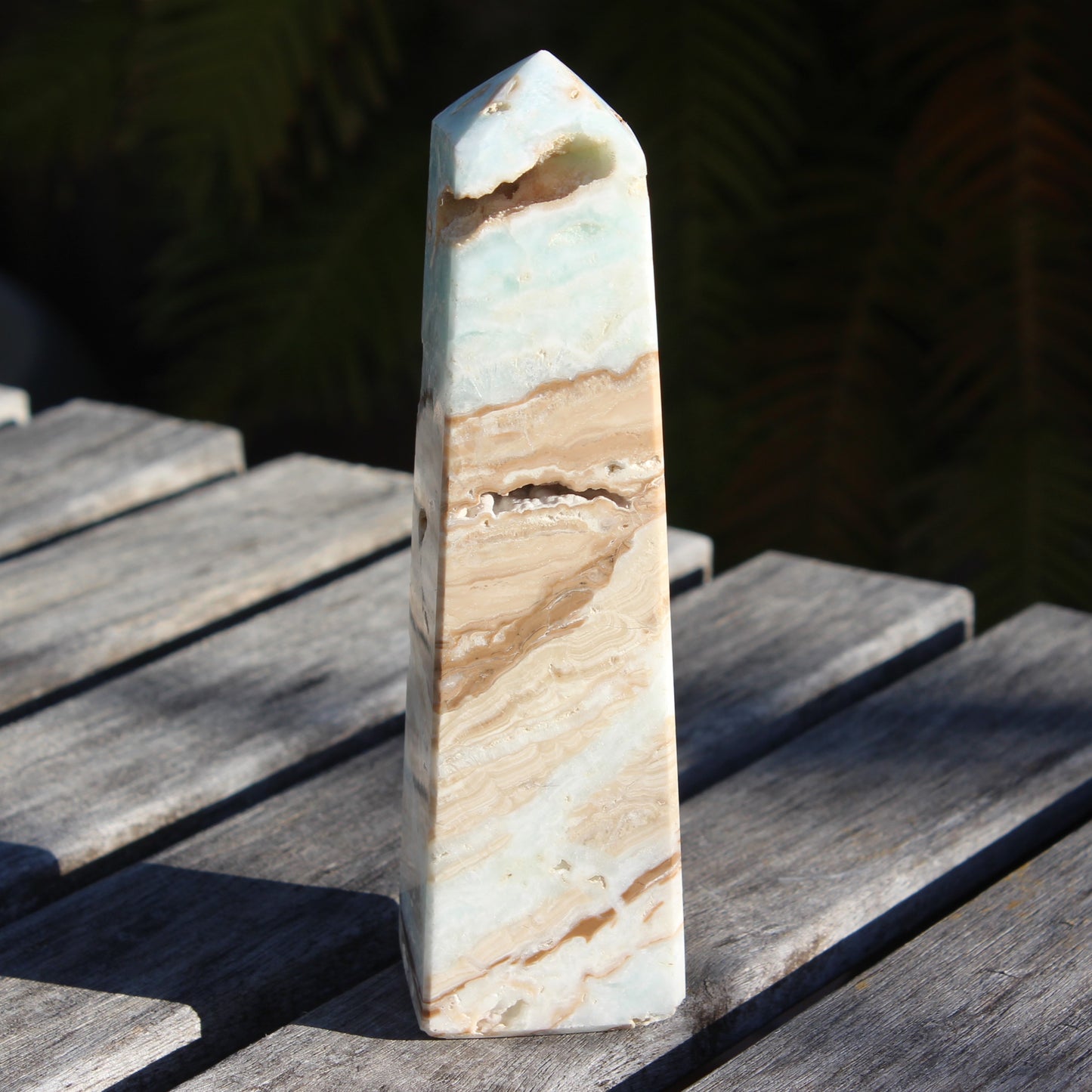 Caribbean aqua blue Calcite obelisk 479g in sunlight - Rocks and Things Store