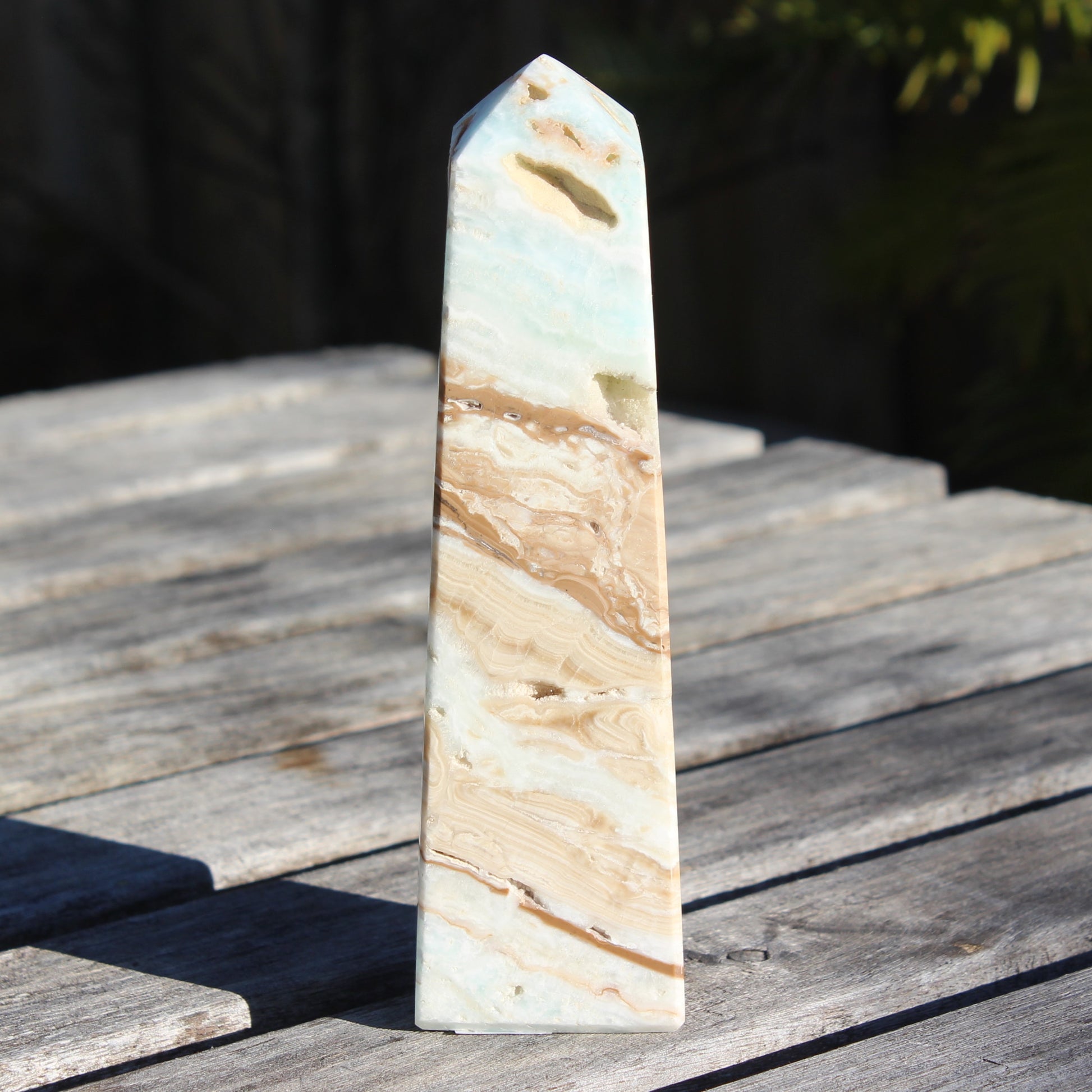 Caribbean aqua blue Calcite obelisk 479g in sunlight - Rocks and Things Store