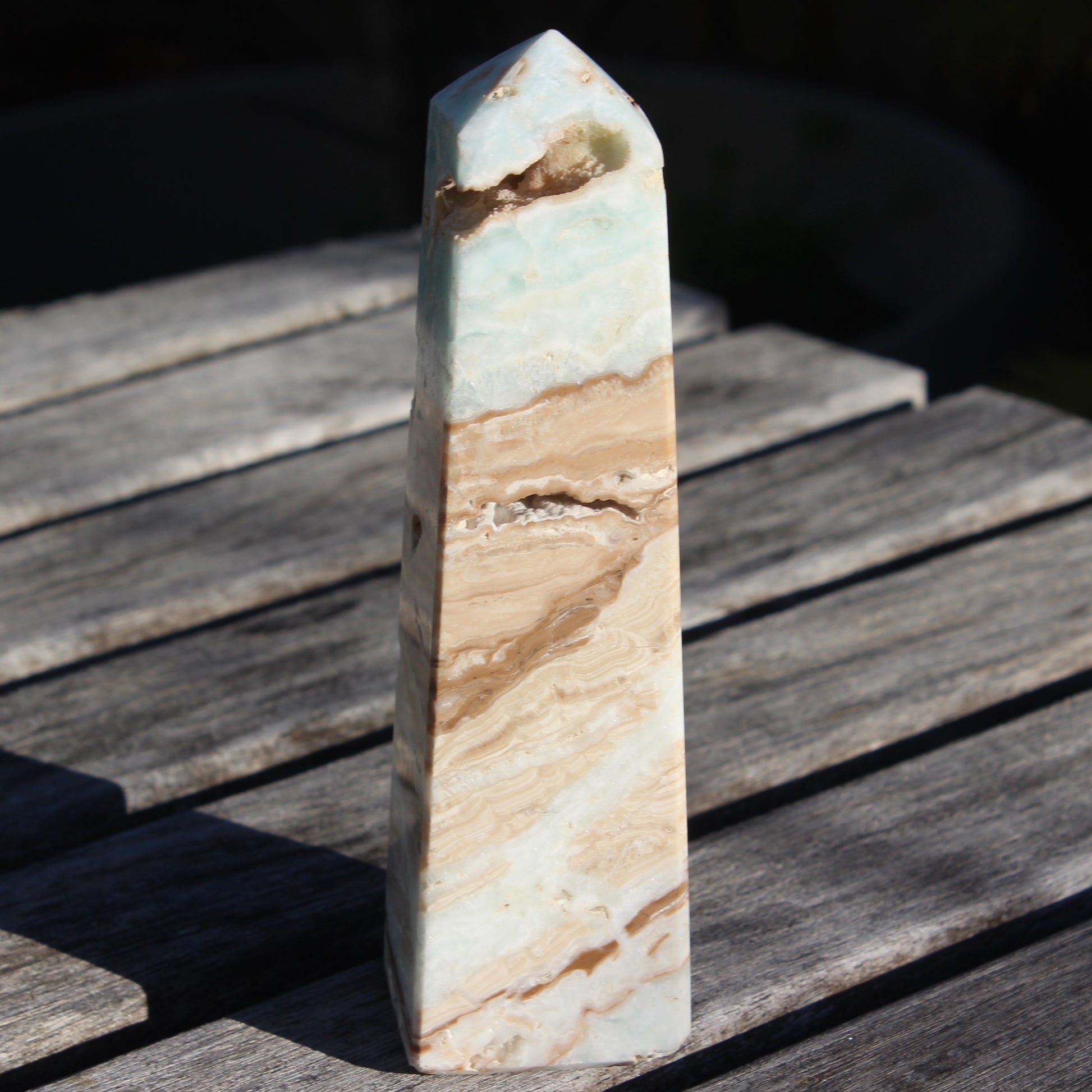 Caribbean aqua blue Calcite obelisk 479g in sunlight - Rocks and Things Store