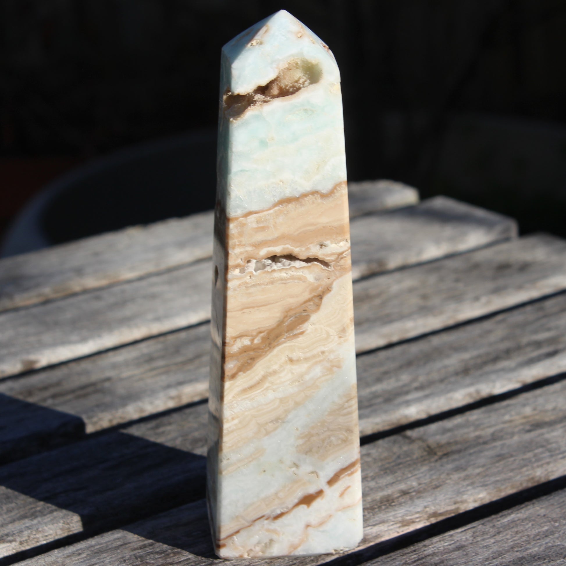 Caribbean aqua blue Calcite obelisk 479g in sunlight - Rocks and Things Store