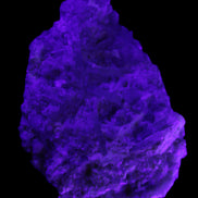 Green Tourmaline cluster on matrix 60*45*37mm 111.8g in UV light - Rocks and Things Store