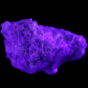 Green Tourmaline cluster on matrix 60*45*37mm 111.8g in UV light - Rocks and Things Store