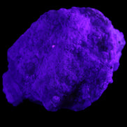 Green Tourmaline cluster on matrix 60*45*37mm 111.8g in UV light - Rocks and Things Store