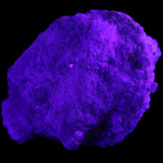 Green Tourmaline cluster on matrix 60*45*37mm 111.8g in UV light - Rocks and Things Store