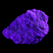 Green Tourmaline cluster on matrix 60*45*37mm 111.8g in UV light - Rocks and Things Store