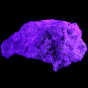 Green Tourmaline cluster on matrix 60*45*37mm 111.8g in UV light - Rocks and Things Store