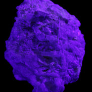 Green Tourmaline cluster on matrix 60*45*37mm 111.8g in UV light - Rocks and Things Store