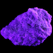 Green Tourmaline cluster on matrix 60*45*37mm 111.8g in UV light - Rocks and Things Store