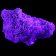 Green Tourmaline cluster on matrix 60*45*37mm 111.8g in UV light - Rocks and Things Store