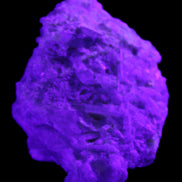 Green Tourmaline cluster on matrix 60*45*37mm 111.8g in UV light - Rocks and Things Store