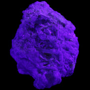 Green Tourmaline cluster on matrix 60*45*37mm 111.8g in UV light - Rocks and Things Store