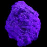 Green Tourmaline cluster on matrix 60*45*37mm 111.8g in UV light - Rocks and Things Store