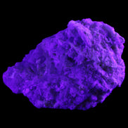 Green Tourmaline cluster on matrix 60*45*37mm 111.8g in UV light - Rocks and Things Store