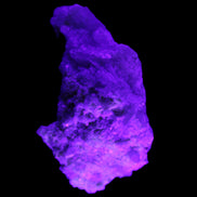 Green Tourmaline cluster on matrix 60*45*37mm 111.8g in UV light - Rocks and Things Store