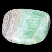 Pistachio Calcite tumbled stone 38*32*14mm 34g in sunlight - Rocks and Things Store