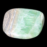 Pistachio Calcite tumbled stone 38*32*14mm 34g in sunlight - Rocks and Things Store