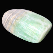 Pistachio Calcite tumbled stone 38*32*14mm 34g in sunlight - Rocks and Things Store