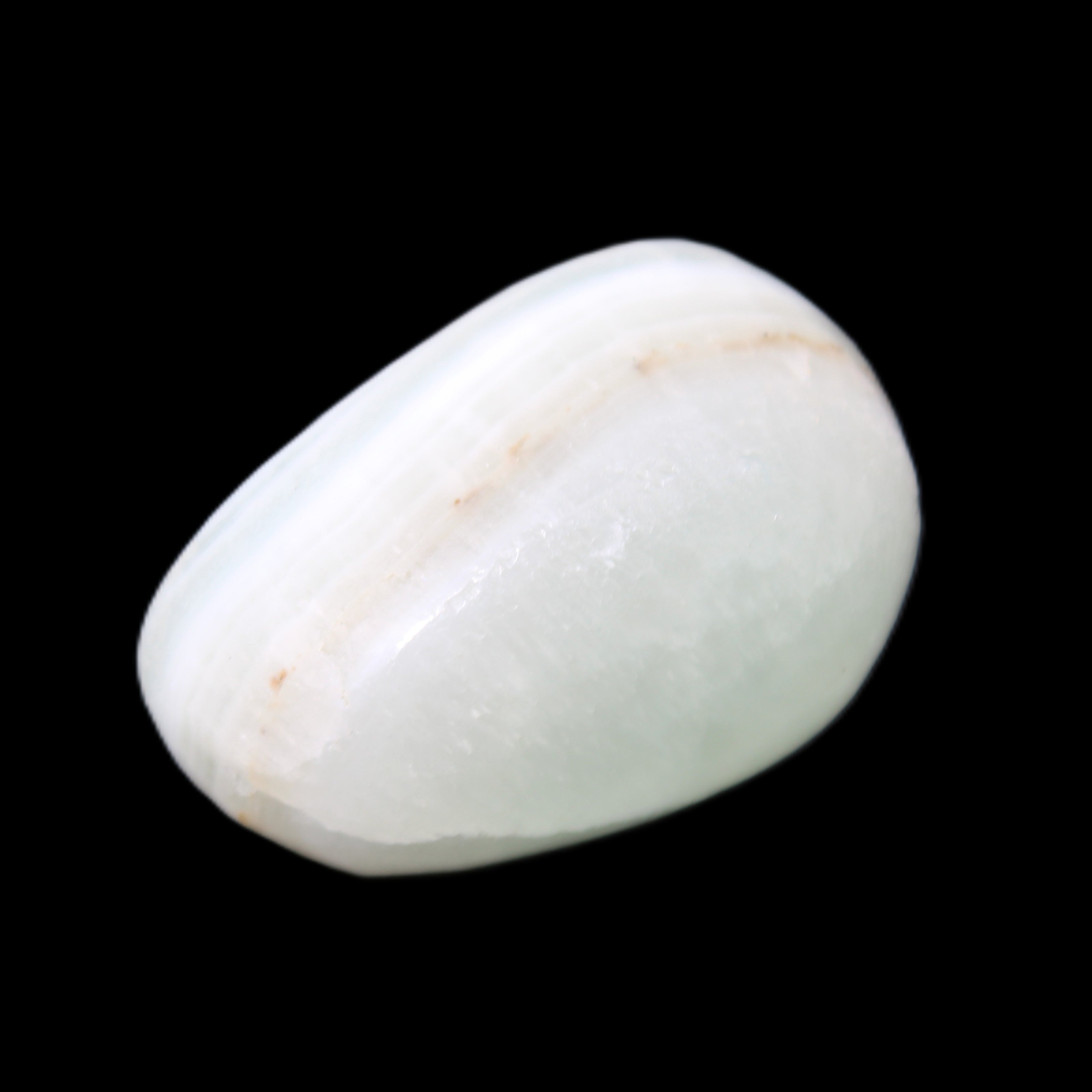 Pistachio Calcite tumbled stone 25-40mm 20-30g in sunlight - Rocks and Things Store