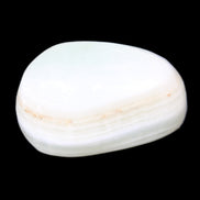 Pistachio Calcite tumbled stone 25-40mm 20-30g in sunlight - Rocks and Things Store