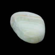 Pistachio Calcite tumbled stone 25-40mm 20-30g in sunlight - Rocks and Things Store