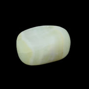 Pistachio Calcite tumbled stone 25-40mm 20-30g in sunlight - Rocks and Things Store