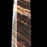 Chocolate Calcite obelisk 113*33*21mm 201g in sunlight - Rocks and Things Store