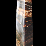 Chocolate Calcite obelisk 113*33*21mm 201g in sunlight - Rocks and Things Store
