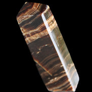 Chocolate Calcite obelisk 113*33*21mm 201g in sunlight - Rocks and Things Store