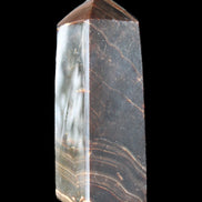 Chocolate Calcite obelisk 105*35*32mm 295g in sunlight - Rocks and Things Store