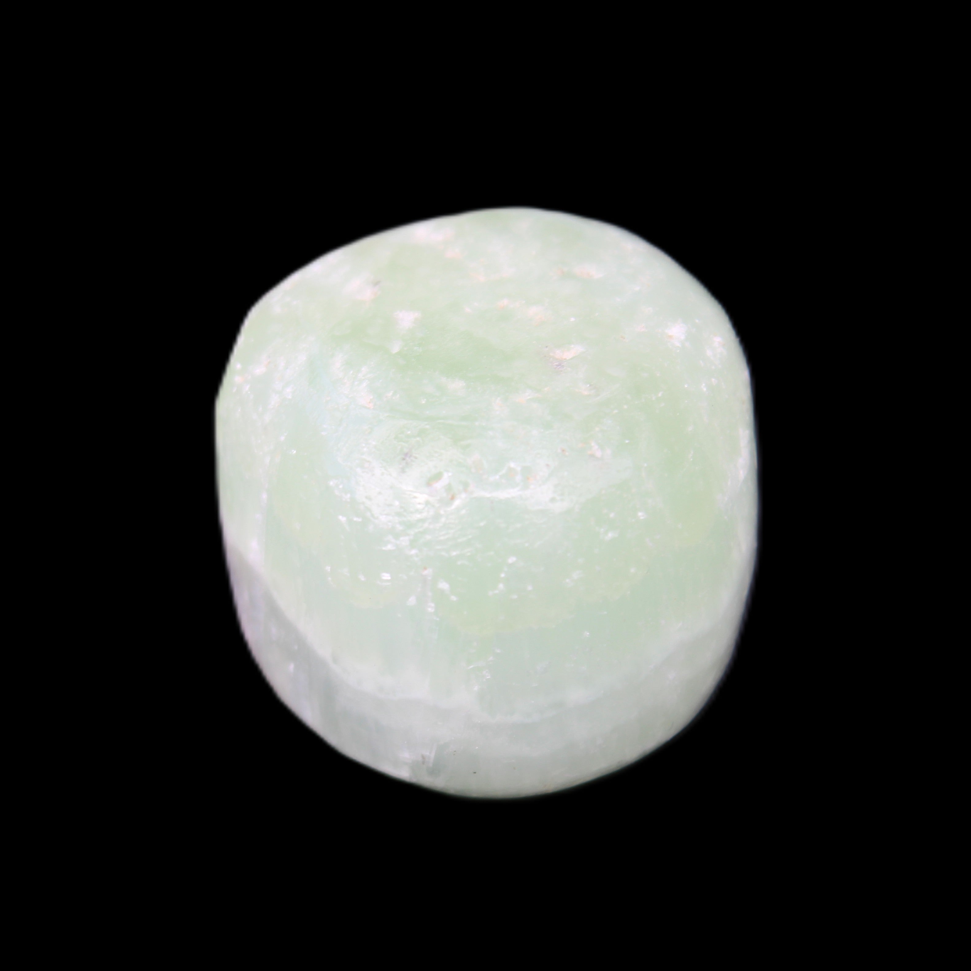 Pistachio Calcite tumbled stone 25-32mm 21-32g in sunlight - Rocks and Things Store