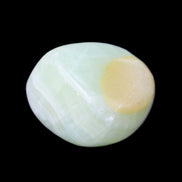 Pistachio Calcite tumbled stone 25-32mm 21-32g in sunlight - Rocks and Things Store