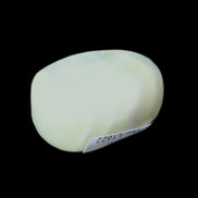 Pistachio Calcite tumbled stone 20-31mm 12-18g in sunlight - Rocks and Things Store