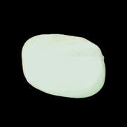 Pistachio Calcite tumbled stone 20-31mm 12-18g in sunlight - Rocks and Things Store