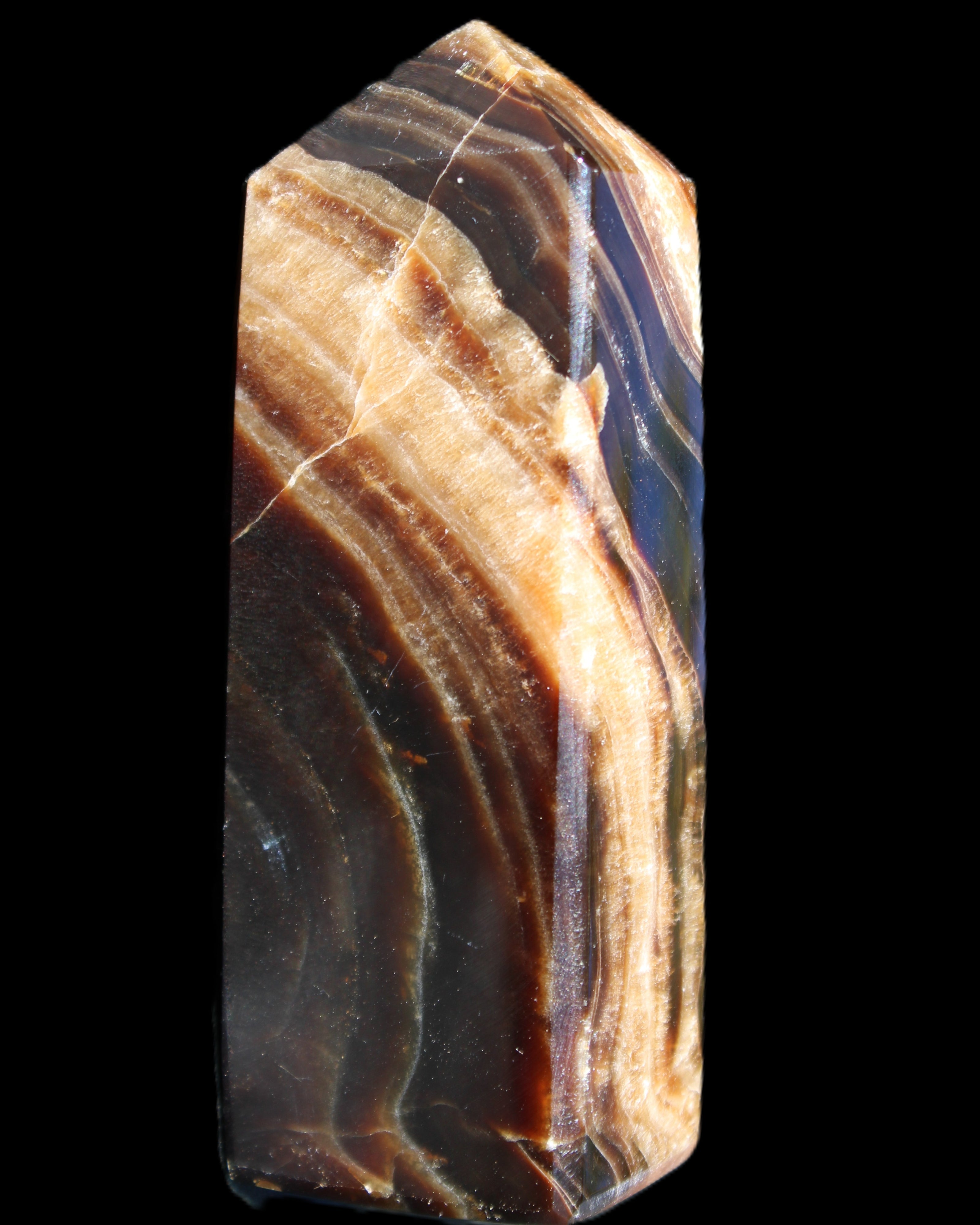 Chocolate Calcite obelisk 95*31*23mm 172g in sunlight - Rocks and Things Store
