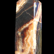 Chocolate Calcite obelisk 95*31*23mm 172g in sunlight - Rocks and Things Store