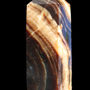 Chocolate Calcite obelisk 95*31*23mm 172g in sunlight - Rocks and Things Store