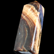 Chocolate Calcite obelisk 95*31*23mm 172g in sunlight - Rocks and Things Store