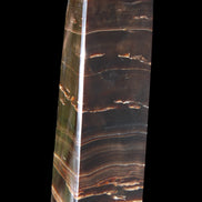 Chocolate Calcite obelisk 110*30*24mm 214g in sunlight - Rocks and Things Store