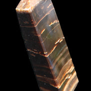 Chocolate Calcite obelisk 110*30*24mm 214g in sunlight - Rocks and Things Store