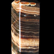Chocolate Calcite obelisk 98*32*30mm 253g in sunlight - Rocks and Things Store
