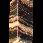 Chocolate Calcite obelisk 98*32*30mm 253g in sunlight - Rocks and Things Store