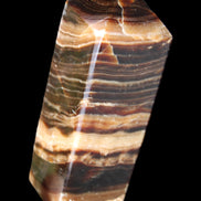 Chocolate Calcite obelisk 98*32*30mm 253g in sunlight - Rocks and Things Store
