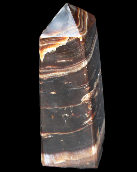Chocolate Calcite obelisk 94*32*31mm 218g in sunlight - Rocks and Things Store