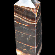 Chocolate Calcite obelisk 94*32*31mm 218g in sunlight - Rocks and Things Store